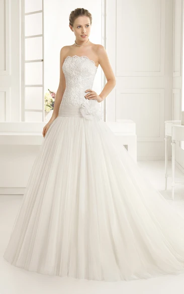 Scalloped Strapless Gown With Dropped Waistline And Flower